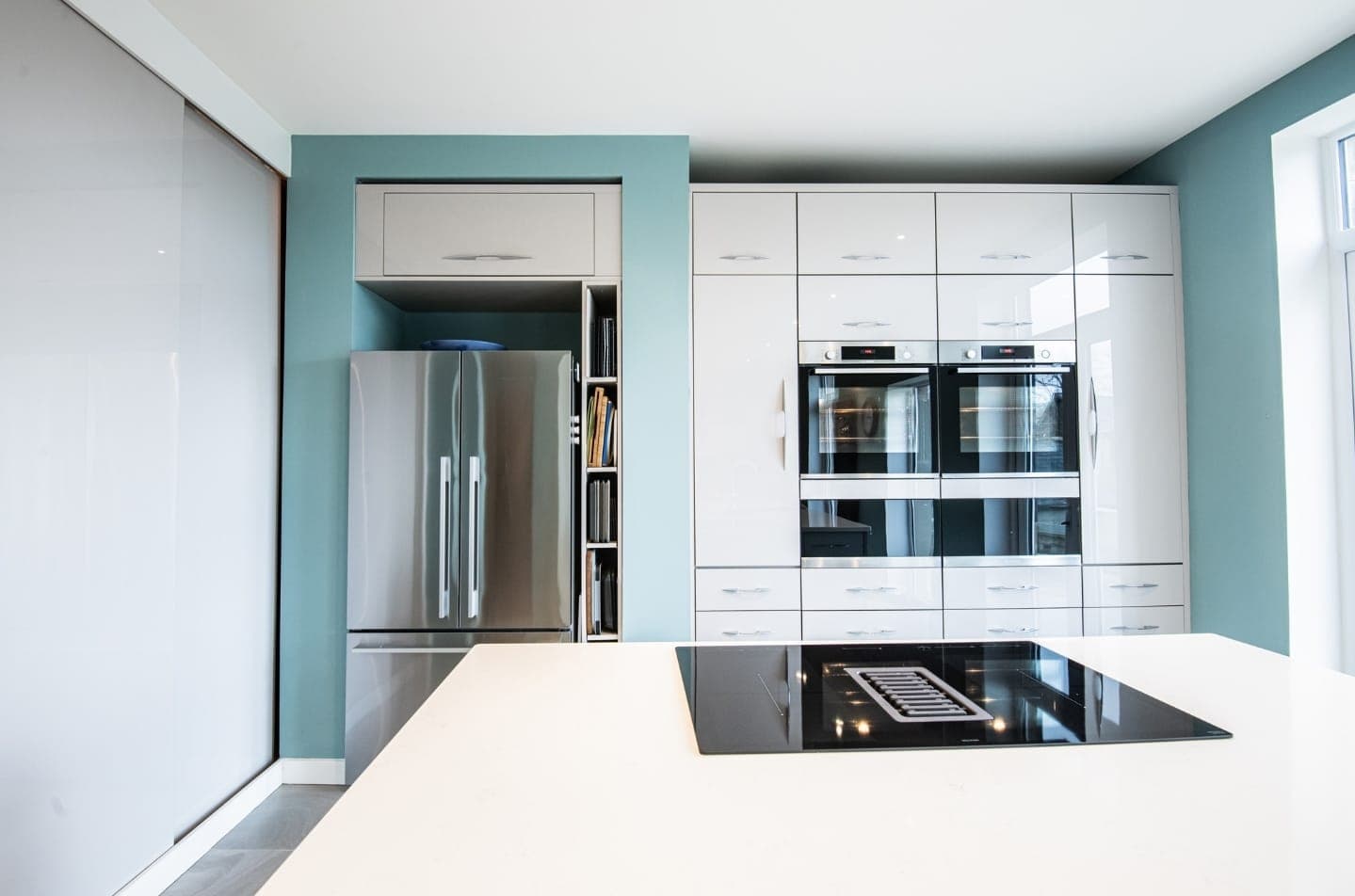 Finished open-plan kitchen renovation in a UK home, with marble island and integrated appliances